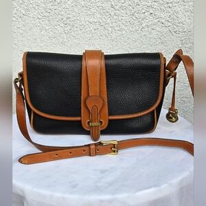 Dooney & Bourke Black and Tan Crossbody Bag with Classic Buckle